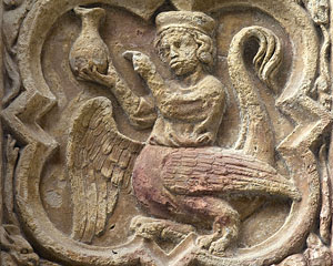 Rouen Cathedral, North Transept Portal, Quatrefoil 09:04 (monster with the lower half of a cockatrice and the upper half of a doctor examining a urine flask)